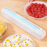 Dispenser multifuncțional pentru folie alimentară cu sistem de tăiere integrat