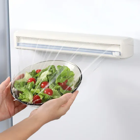 Dispenser multifuncțional pentru folie alimentară cu sistem de tăiere integrat